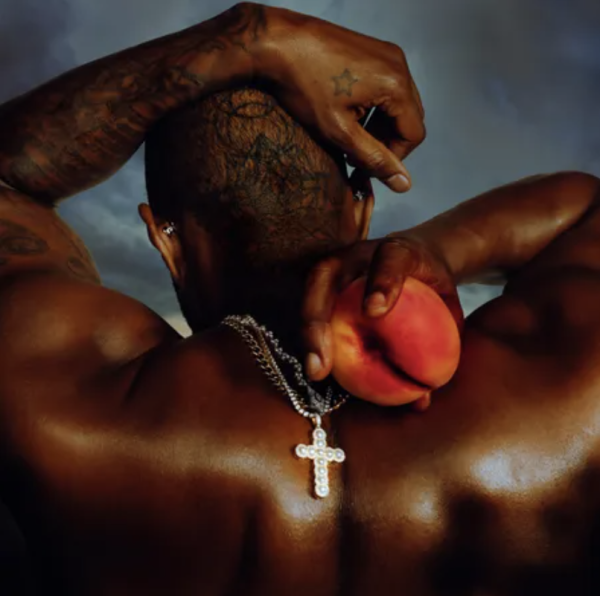 The Coming Home album cover features award-winning singer Usher holding a peach, symbolizing his hometown Atlanta, Georgia. 